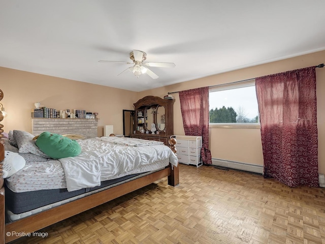 bedroom featuring ceiling fan, light parquet flooring, and a baseboard radiator