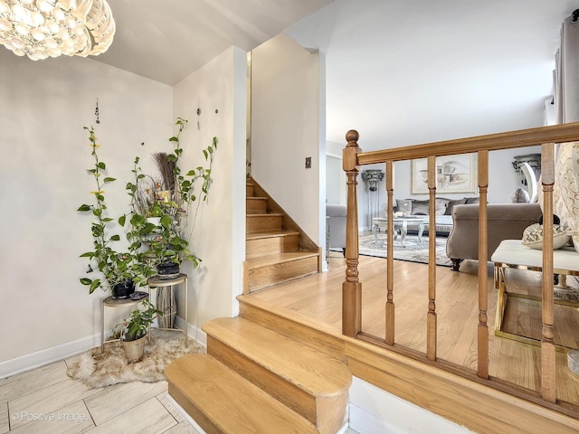 stairs with a chandelier