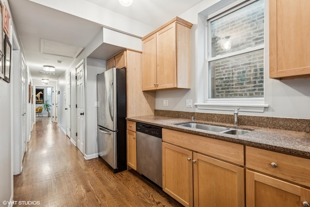 kitchen featuring light brown cabinetry, sink, hardwood / wood-style flooring, and stainless steel appliances