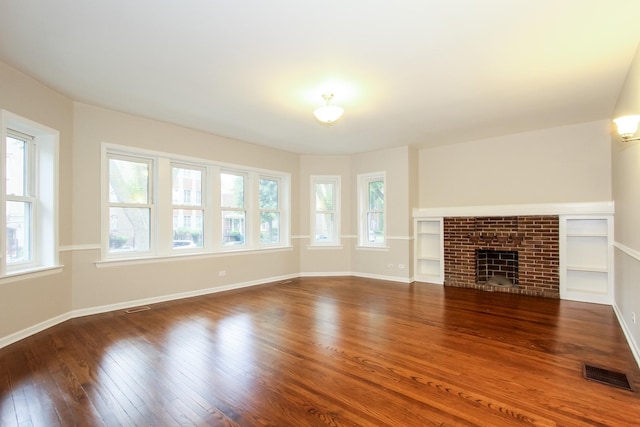 unfurnished living room featuring wood-type flooring and a fireplace