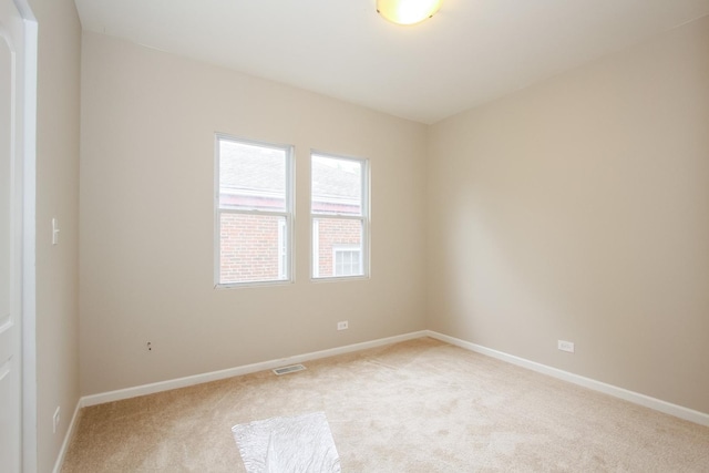 empty room featuring light carpet