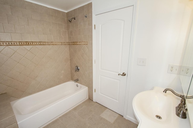 bathroom featuring sink, tile patterned flooring, and tiled shower / bath