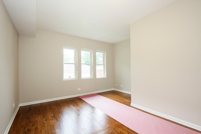 unfurnished room with hardwood / wood-style flooring