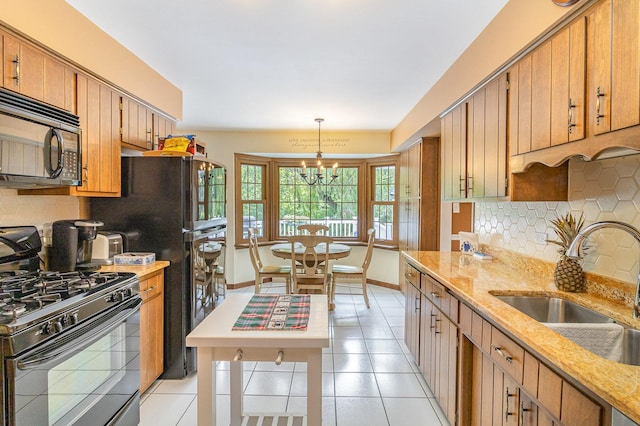 kitchen with decorative backsplash, sink, black appliances, an inviting chandelier, and hanging light fixtures