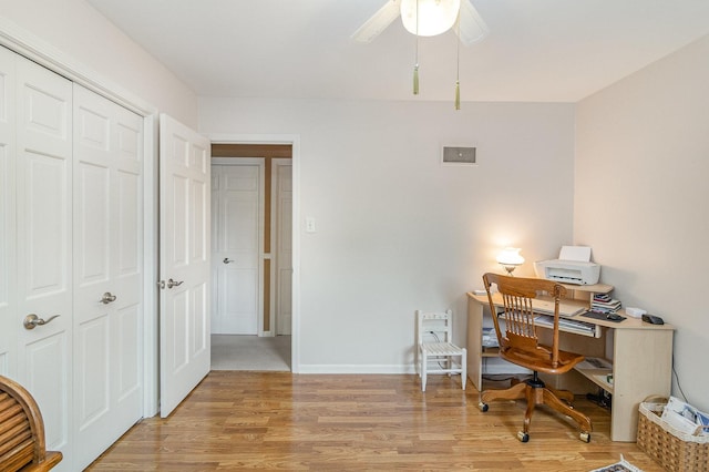 home office featuring light wood-type flooring and ceiling fan