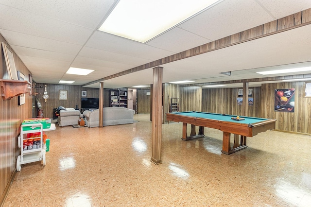 game room featuring a drop ceiling, wood walls, and pool table