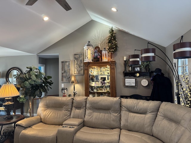 living room featuring ceiling fan and lofted ceiling