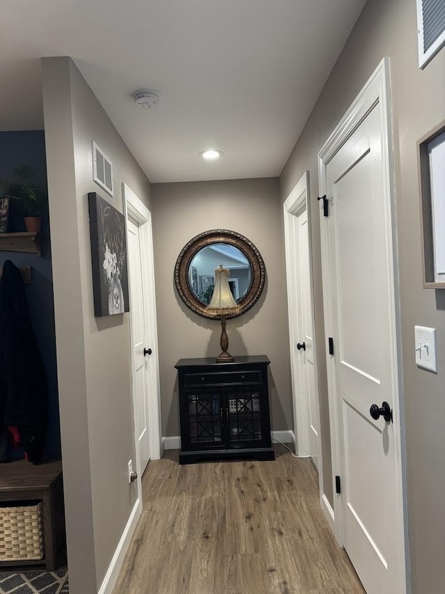 corridor featuring light hardwood / wood-style floors