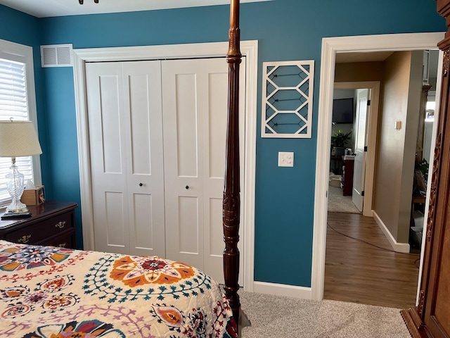 carpeted bedroom with a closet