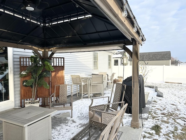 snow covered patio with a gazebo