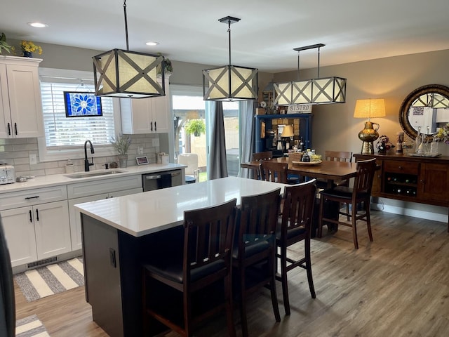 kitchen featuring white cabinets, pendant lighting, and a kitchen island