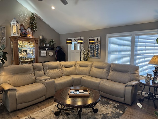 living room with ceiling fan, dark hardwood / wood-style flooring, and vaulted ceiling