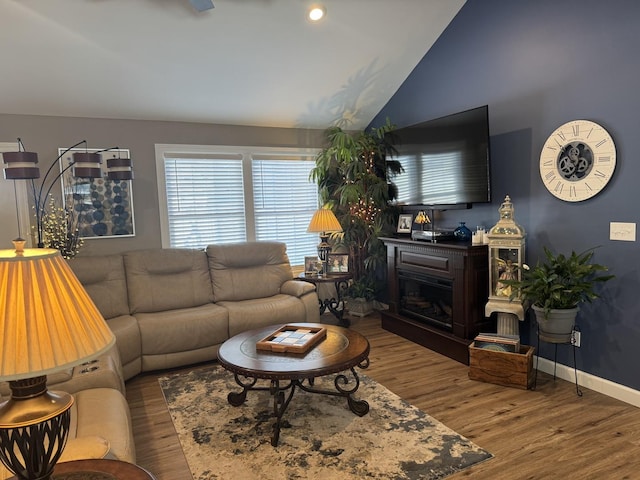 living room with hardwood / wood-style flooring and vaulted ceiling