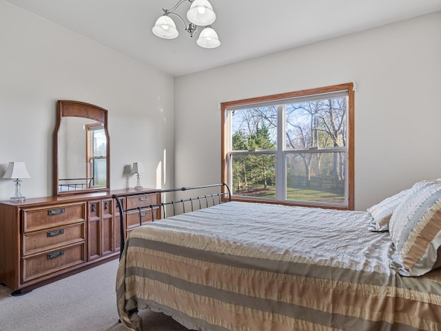 bedroom featuring a chandelier and carpet floors