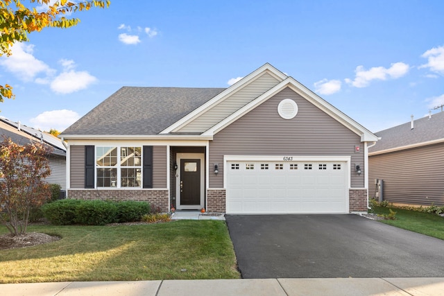 view of front of house featuring a garage and a front lawn