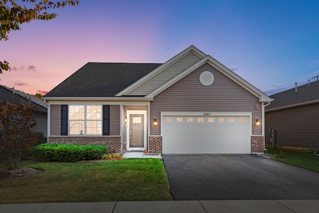 view of front of home with a lawn and a garage