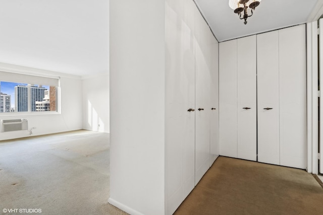 hall featuring carpet flooring and a wall unit AC