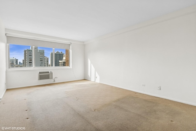 carpeted spare room featuring crown molding and an AC wall unit