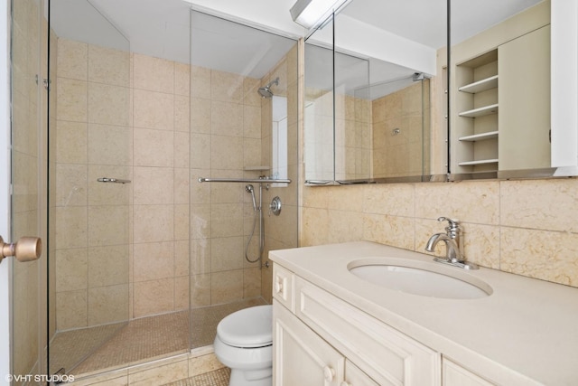 bathroom featuring walk in shower, toilet, tasteful backsplash, vanity, and tile patterned flooring