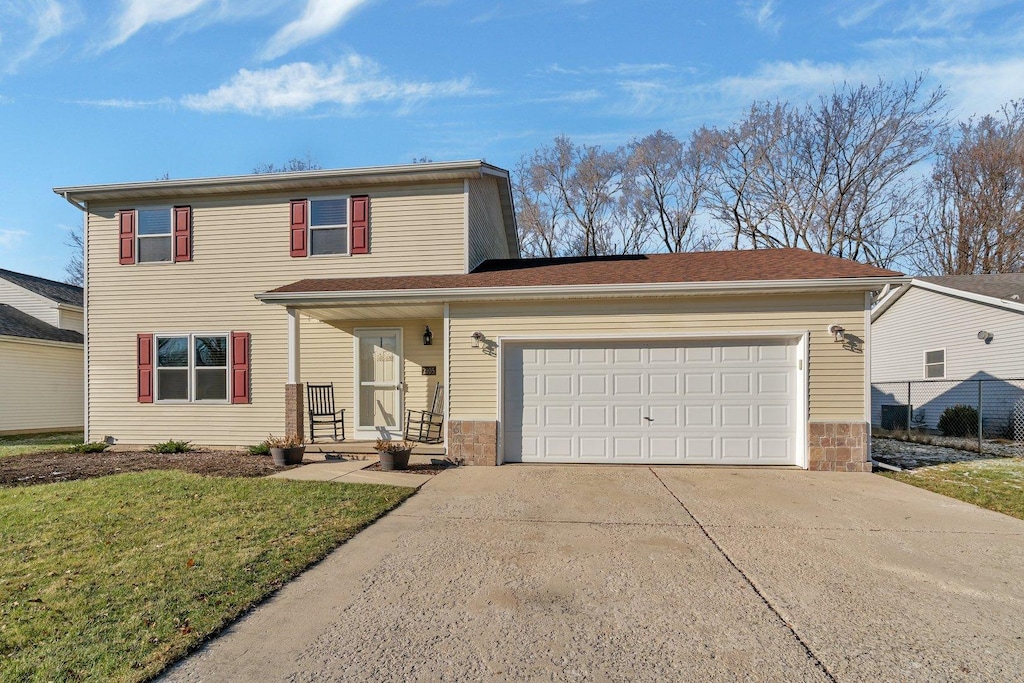 view of property featuring a front yard and a garage