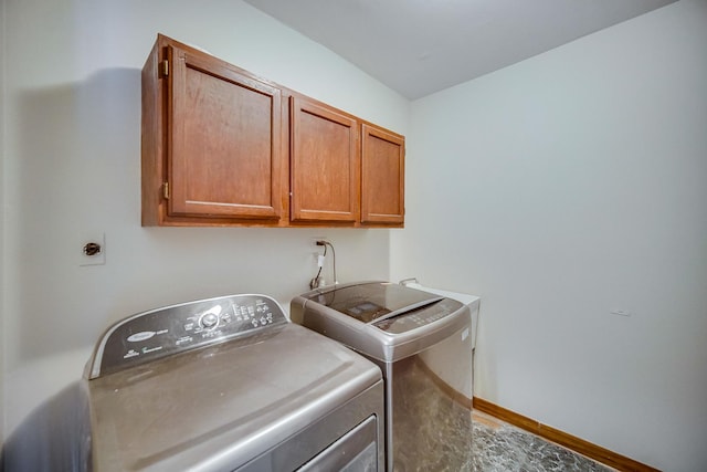 washroom featuring cabinets and independent washer and dryer