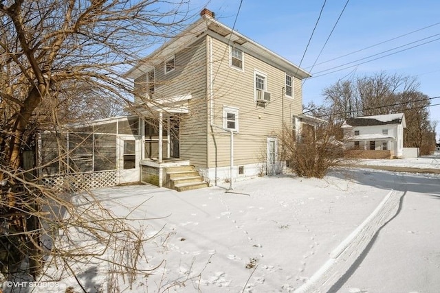 snow covered property with cooling unit