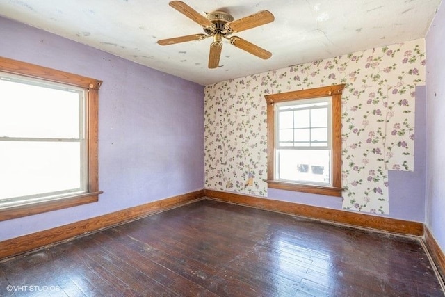 unfurnished room with dark hardwood / wood-style flooring and ceiling fan