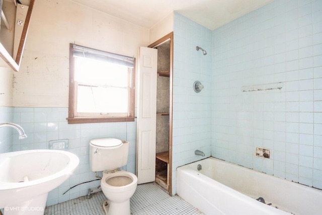 full bathroom with tile patterned flooring, separate shower and tub, toilet, and tile walls