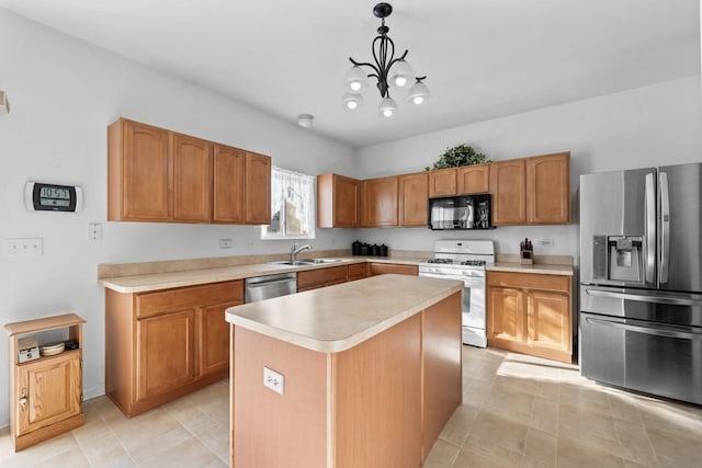 kitchen with an inviting chandelier, appliances with stainless steel finishes, a center island, pendant lighting, and sink