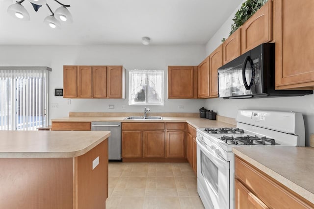 kitchen with a healthy amount of sunlight, stainless steel dishwasher, white range with gas stovetop, and sink