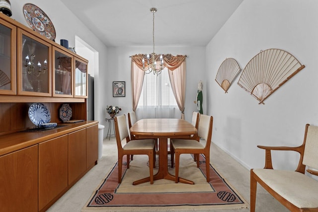 carpeted dining space featuring a chandelier