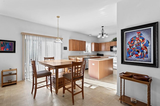 tiled dining space with an inviting chandelier and sink