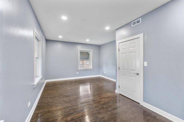 empty room featuring dark wood-type flooring