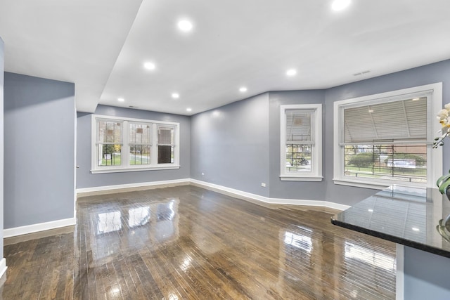 unfurnished living room with dark wood-type flooring