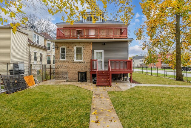 back of property featuring a yard, a balcony, a deck, and a patio area