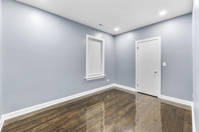 unfurnished room featuring dark wood-type flooring