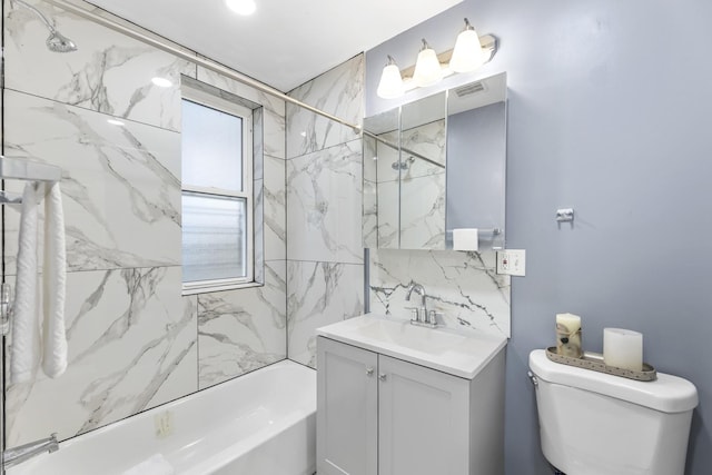 full bathroom with vanity, tiled shower / bath combo, and toilet