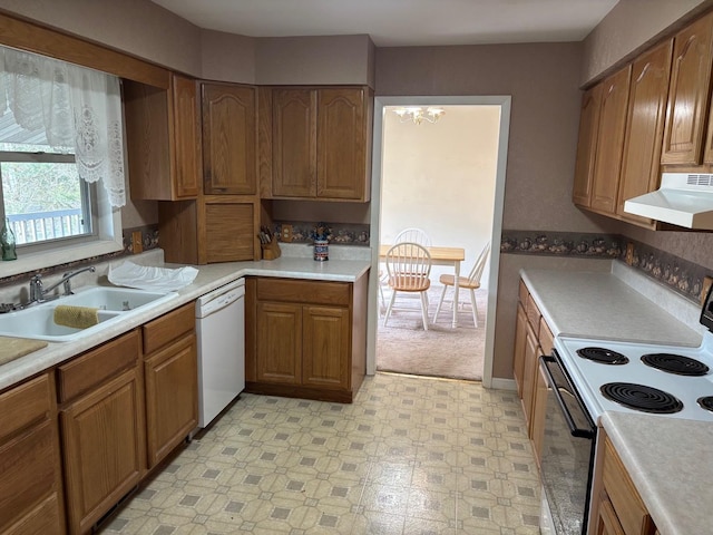 kitchen featuring white dishwasher, sink, black / electric stove, and a chandelier