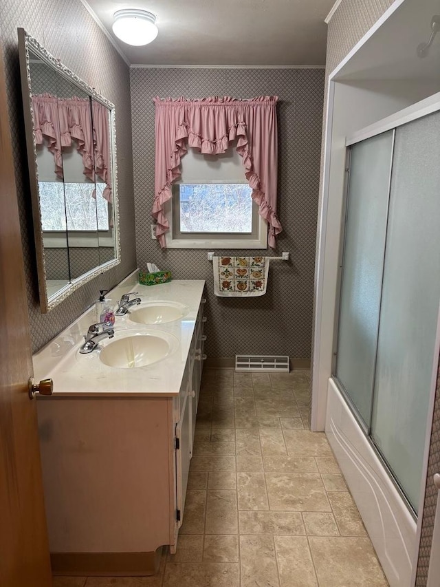 bathroom featuring vanity, crown molding, and enclosed tub / shower combo