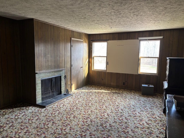 unfurnished living room with wood walls and a healthy amount of sunlight