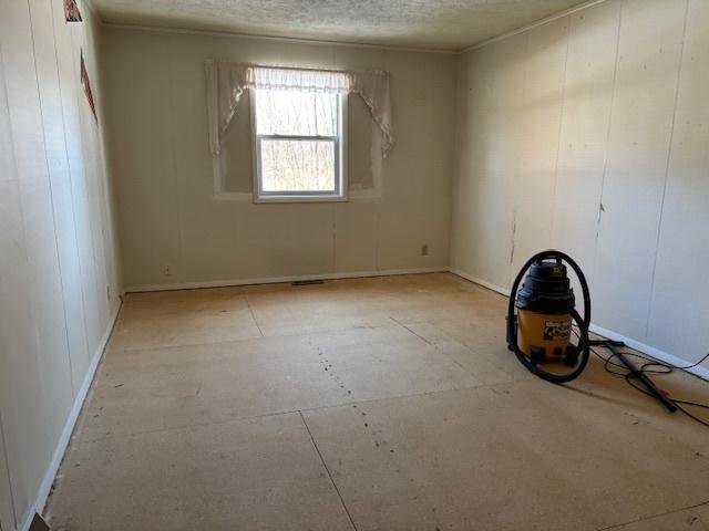 spare room featuring a textured ceiling