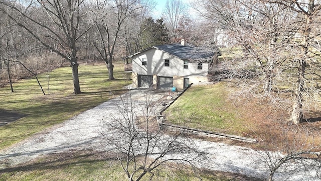 exterior space featuring a garage and a lawn