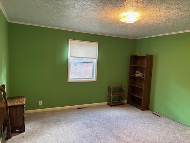 interior space with carpet, ornamental molding, and a textured ceiling