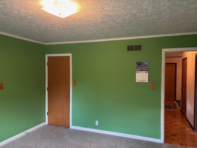 unfurnished room featuring ornamental molding and a textured ceiling