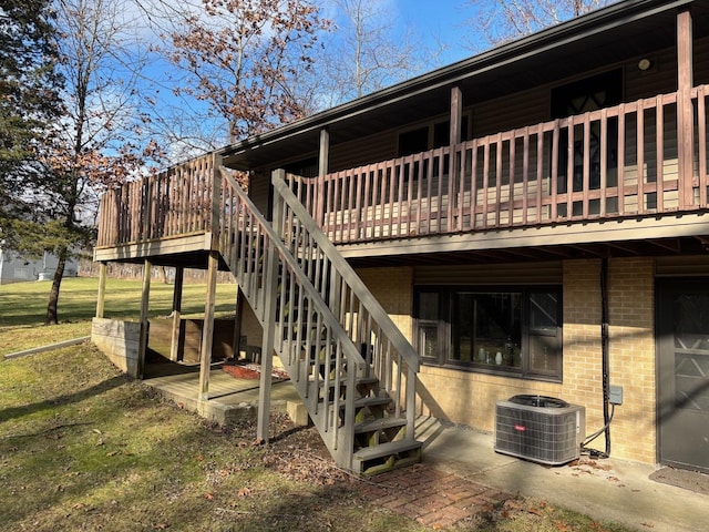 back of house with central air condition unit, a yard, a patio, and a wooden deck