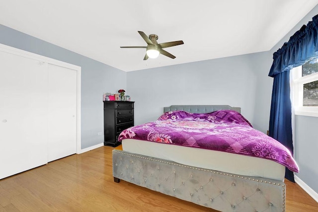 bedroom featuring ceiling fan, a closet, and hardwood / wood-style flooring