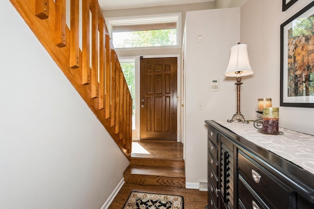 entrance foyer featuring stairway, wood finished floors, and baseboards