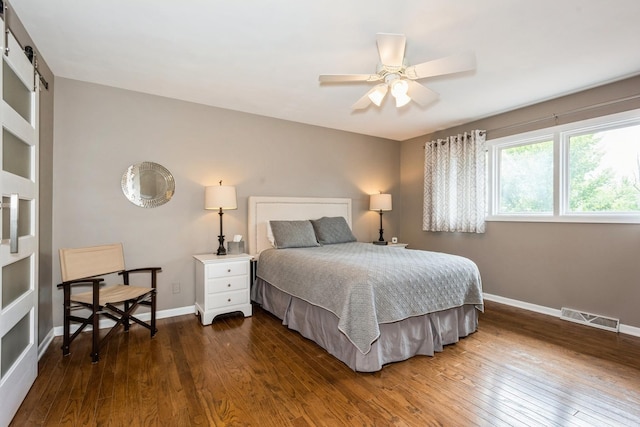 bedroom with a ceiling fan, dark wood-style flooring, visible vents, and baseboards