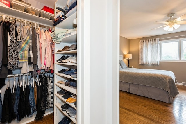 spacious closet featuring wood finished floors and a ceiling fan