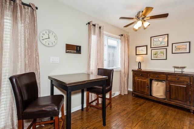 dining room featuring a ceiling fan, dark wood-style flooring, and baseboards